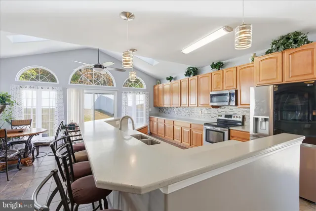 a large kitchen with a table and chairs