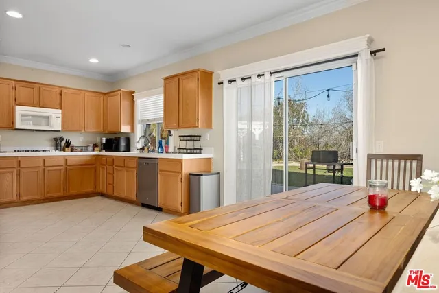 a very nice looking kitchen with a large window a dining table and chairs