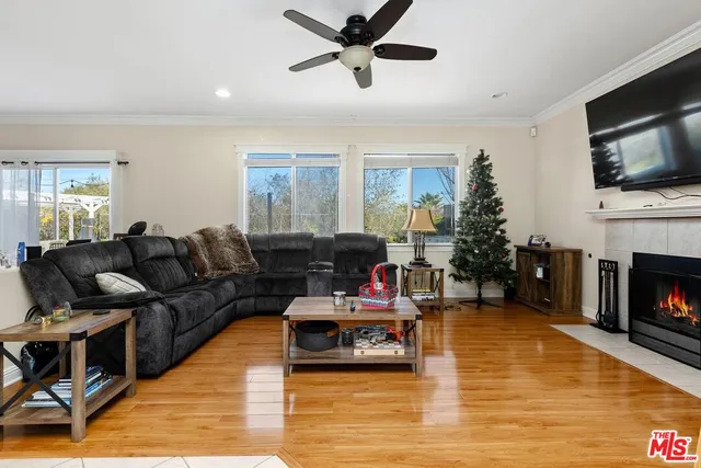 a living room with furniture a flat screen tv and a fireplace