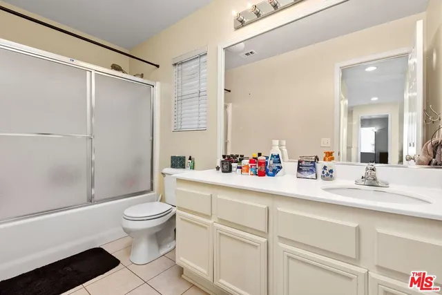 a bathroom with a sink mirror vanity and toilet