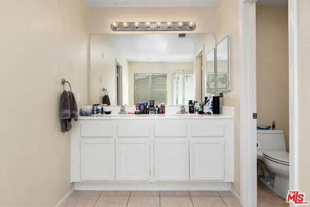 a bathroom with a sink vanity and a mirror