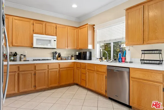 a kitchen with stainless steel appliances granite countertop refrigerator sink and cabinets