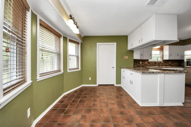 a kitchen with a refrigerator a stove top oven a sink and dishwasher