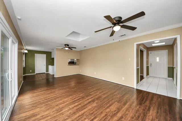 wooden floor in an empty room with a window
