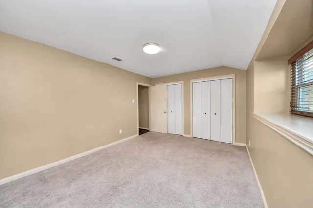 a view of an empty room and a window