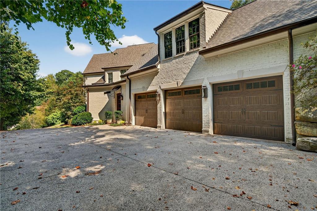 120 Burdette Trail Atlanta, GA 30327 - Photo 68 of 69 a front view of a house with a yard and garage