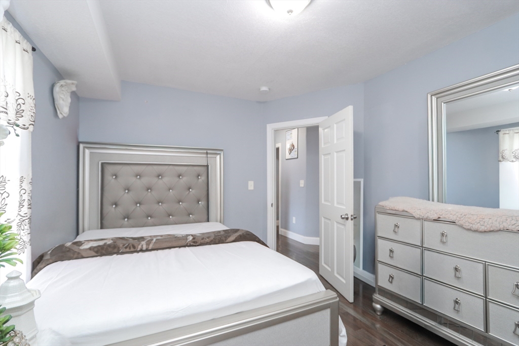 58 Willard Avenue Springfield, MA 01109 - Photo 19 of 32 a bedroom with a bed and a dresser