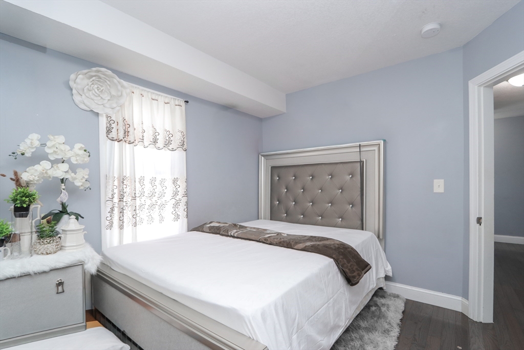 58 Willard Avenue Springfield, MA 01109 - Photo 20 of 32 a bedroom with a large bed and a window