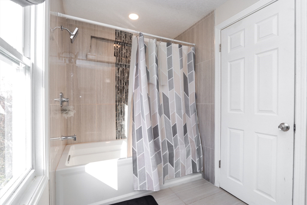 58 Willard Avenue Springfield, MA 01109 - Photo 22 of 32 a bathroom with a shower and a tub