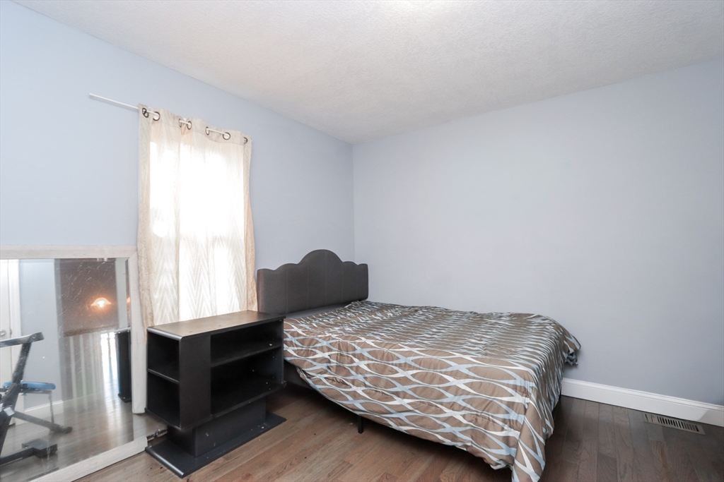 58 Willard Avenue Springfield, MA 01109 - Photo 25 of 32 a bedroom with a bed and window