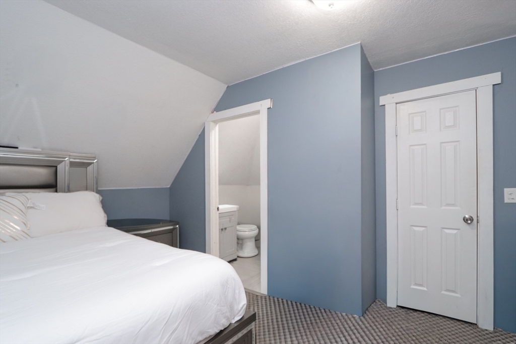 58 Willard Avenue Springfield, MA 01109 - Photo 29 of 32 a bedroom with a bed and wooden floor