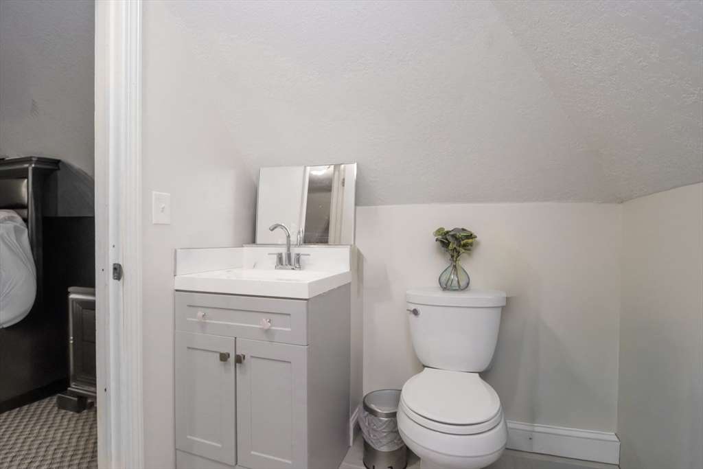 58 Willard Avenue Springfield, MA 01109 - Photo 30 of 32 a bathroom with a toilet a sink and mirror