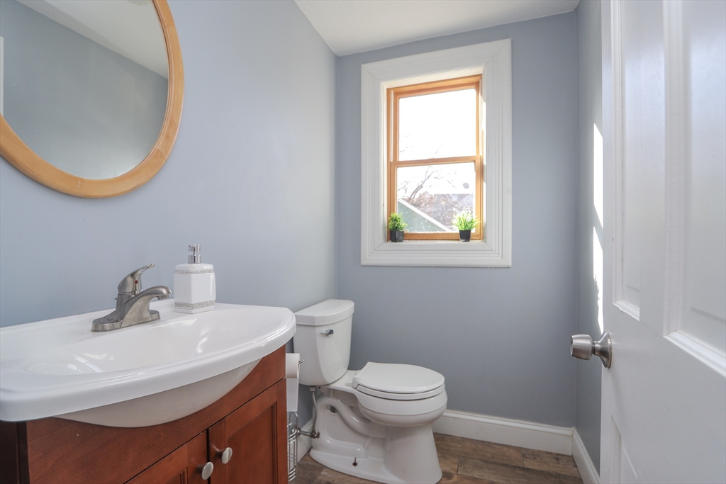 58 Willard Avenue Springfield, MA 01109 - Photo 9 of 32 a bathroom with a sink a mirror and a toilet