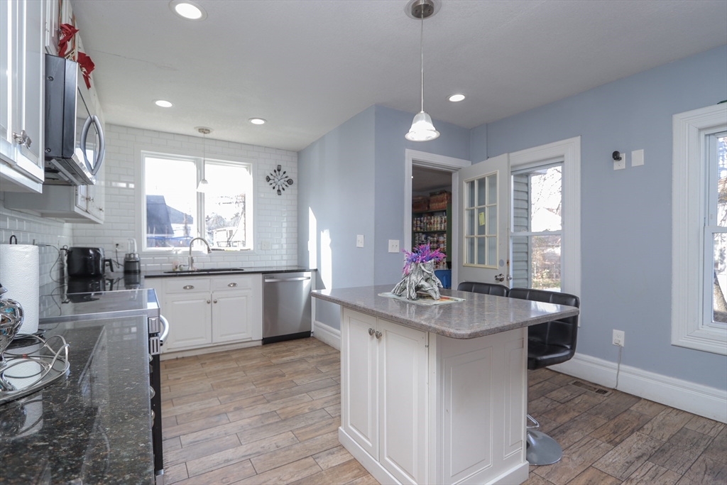 58 Willard Avenue Springfield, MA 01109 - Photo 10 of 32 a kitchen with sink stove and cabinets