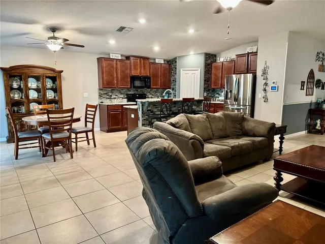 a living room kitchen with furniture and kitchen view