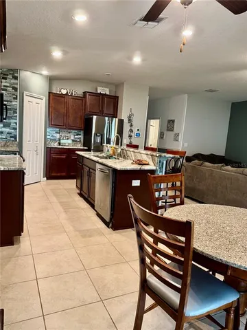 a kitchen with stainless steel appliances granite countertop a sink stove and cabinets