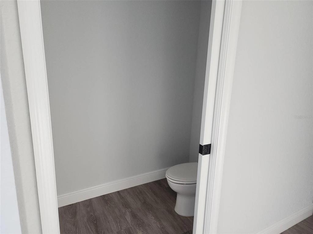 1111 Dagmar Avenue Spring Hill, FL 34606 - Photo 21 of 27 a white toilet sitting next to a white wall