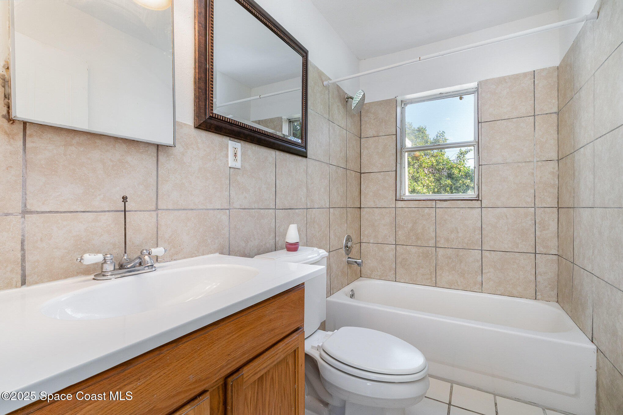 2234 Post Road Melbourne, FL 32935 - Photo 13 of 29 a bathroom with a sink a toilet and bathtub