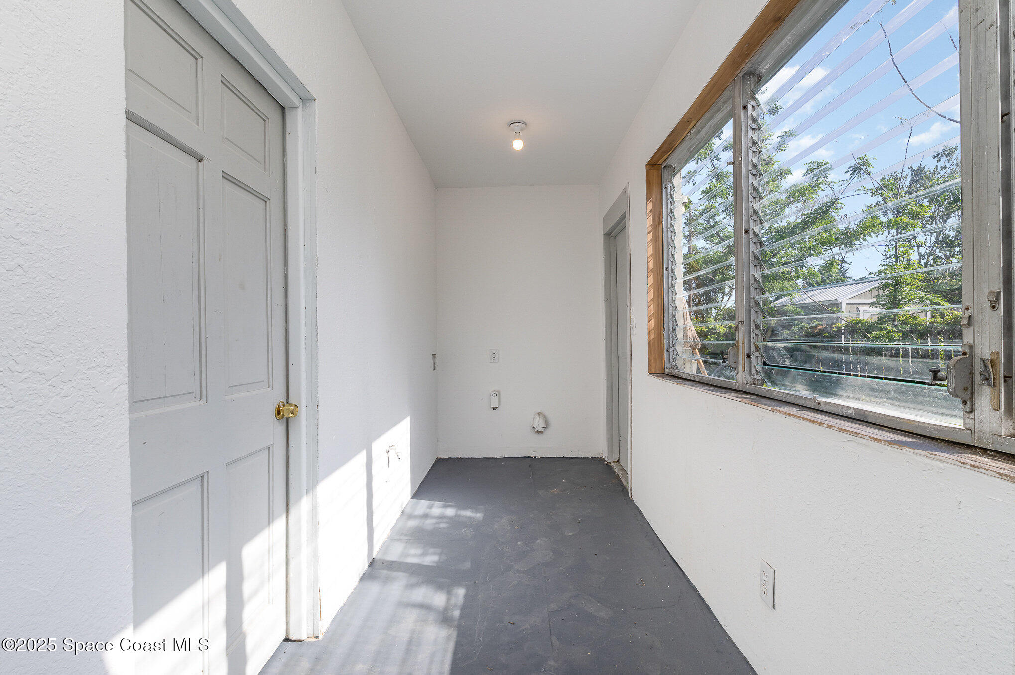 2234 Post Road Melbourne, FL 32935 - Photo 16 of 29 a view of a big room with wooden floor and windows