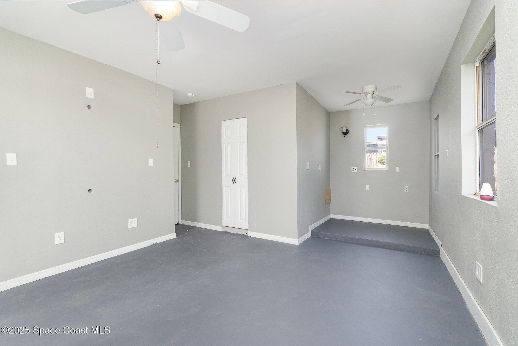 2234 Post Road Melbourne, FL 32935 - Photo 17 of 29 an empty room with closet and windows