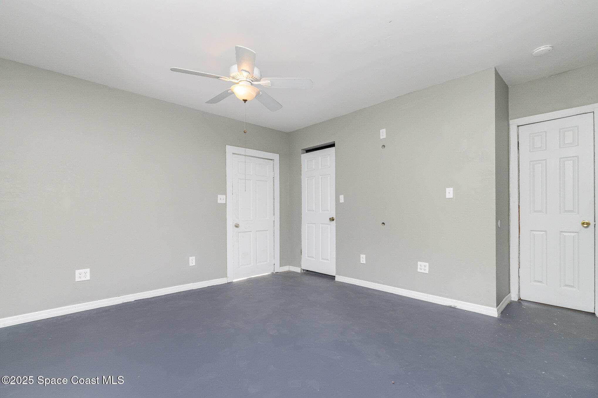 2234 Post Road Melbourne, FL 32935 - Photo 18 of 29 a view of an empty room with a chandelier fan