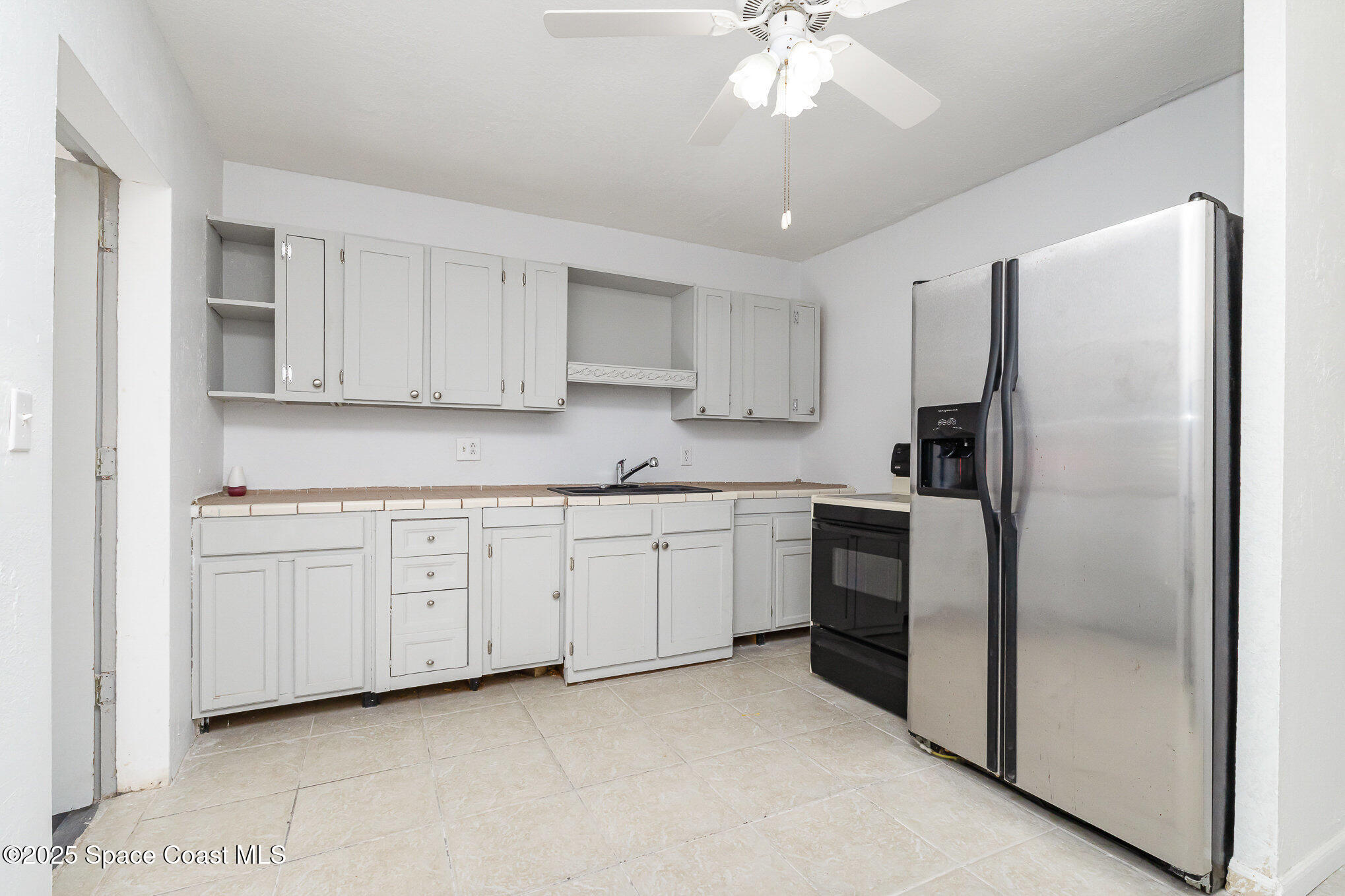 2234 Post Road Melbourne, FL 32935 - Photo 2 of 29 a kitchen with cabinets stainless steel appliances and a counter space
