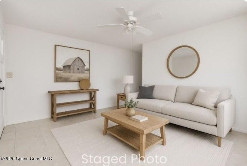 2234 Post Road Melbourne, FL 32935 - Photo 3 of 29 a living room with a couch and a potted plant