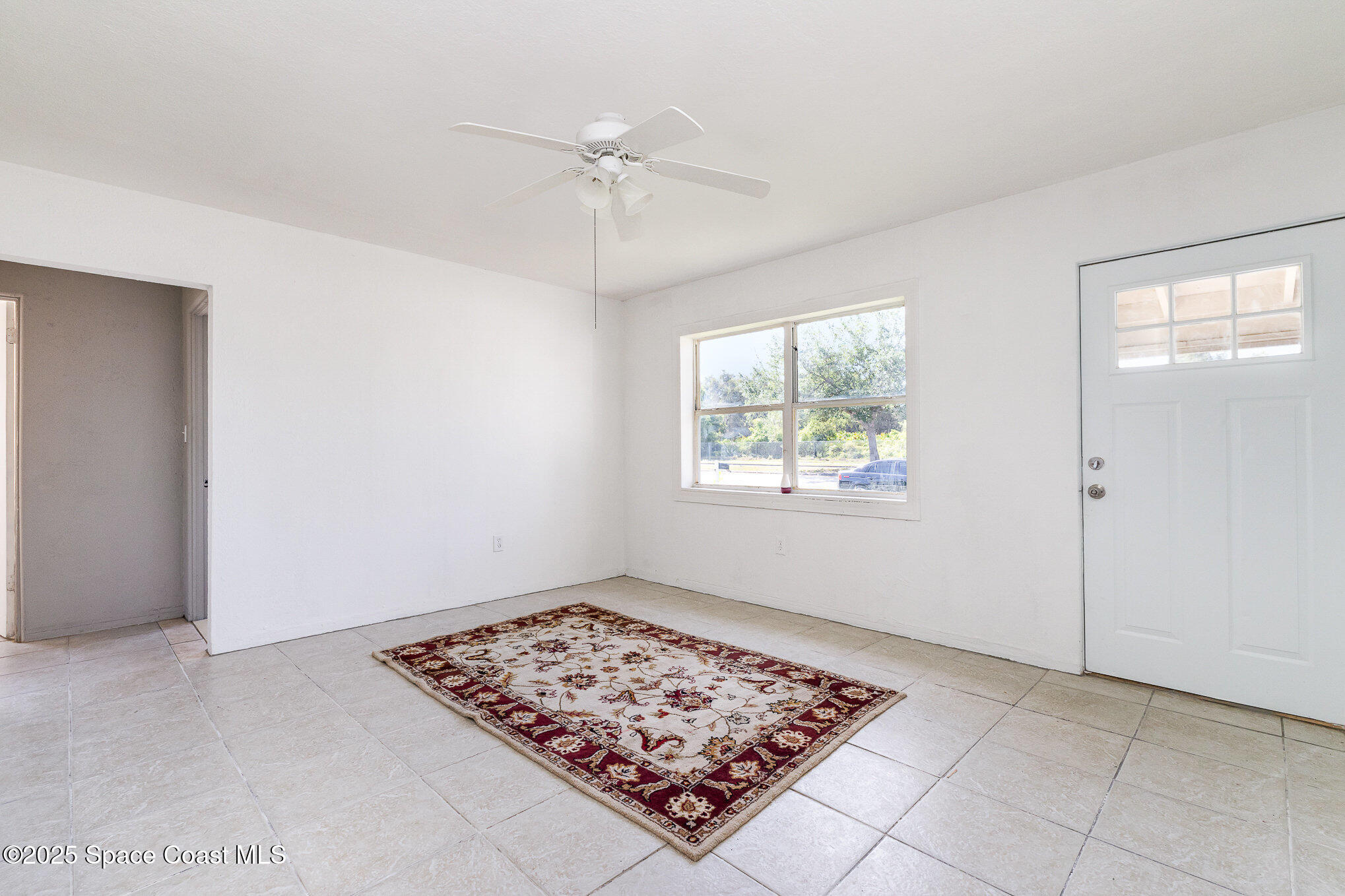 2234 Post Road Melbourne, FL 32935 - Photo 6 of 29 a view of an empty room with window and chandelier fan