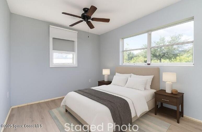 2234 Post Road Melbourne, FL 32935 - Photo 7 of 29 a bedroom with a large bed and a window