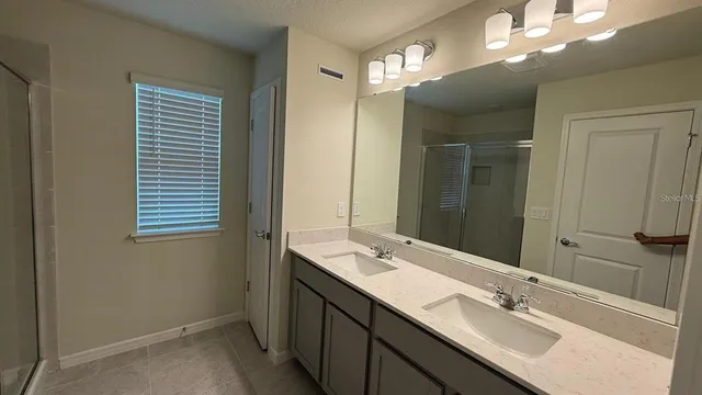 a bathroom with a sink double vanity and a mirror
