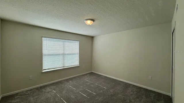 an empty room with a empty space and windows