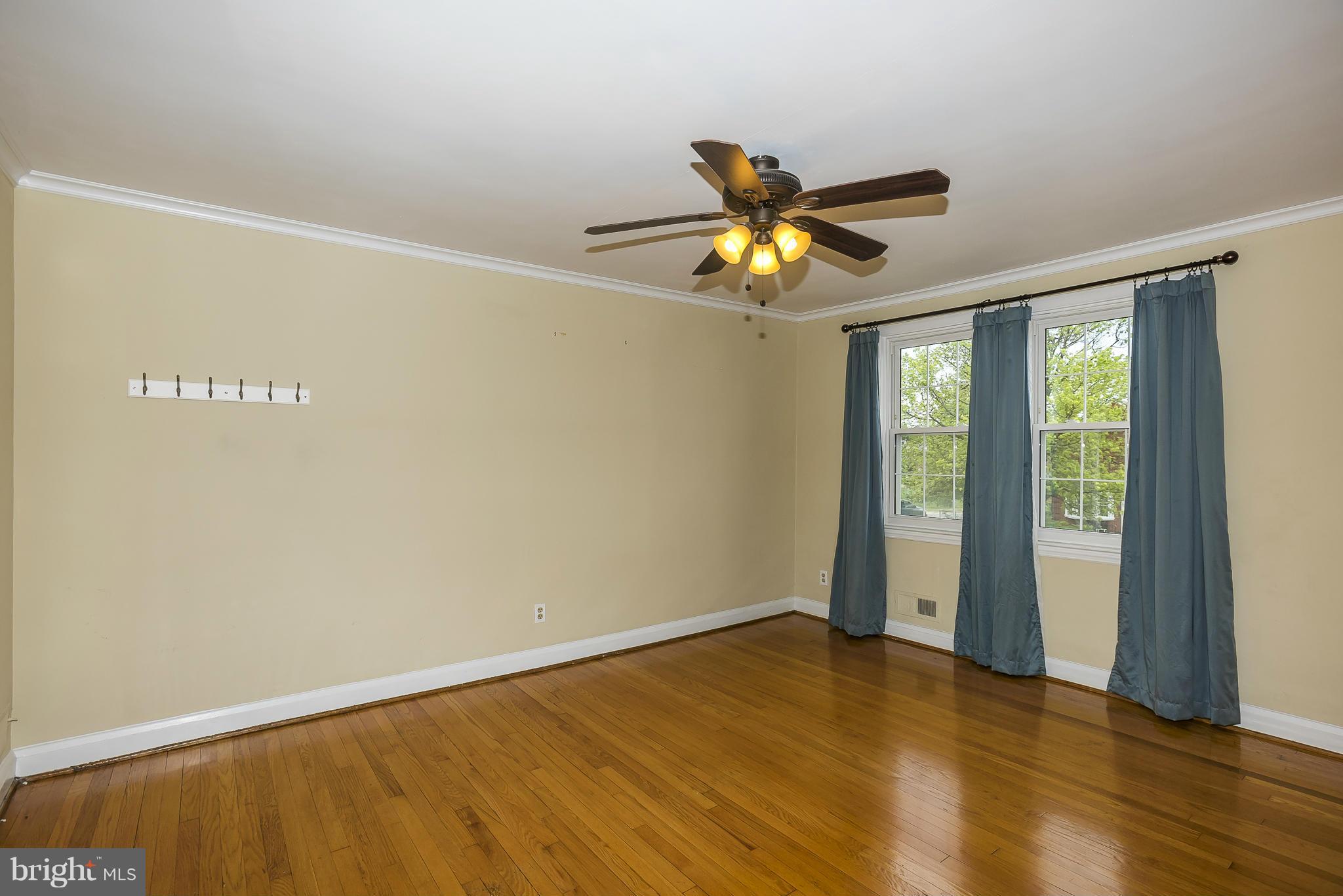 354 Greenlow Road Catonsville, MD 21228 - Photo 11 of 20 a view of an empty room with window and wooden floor