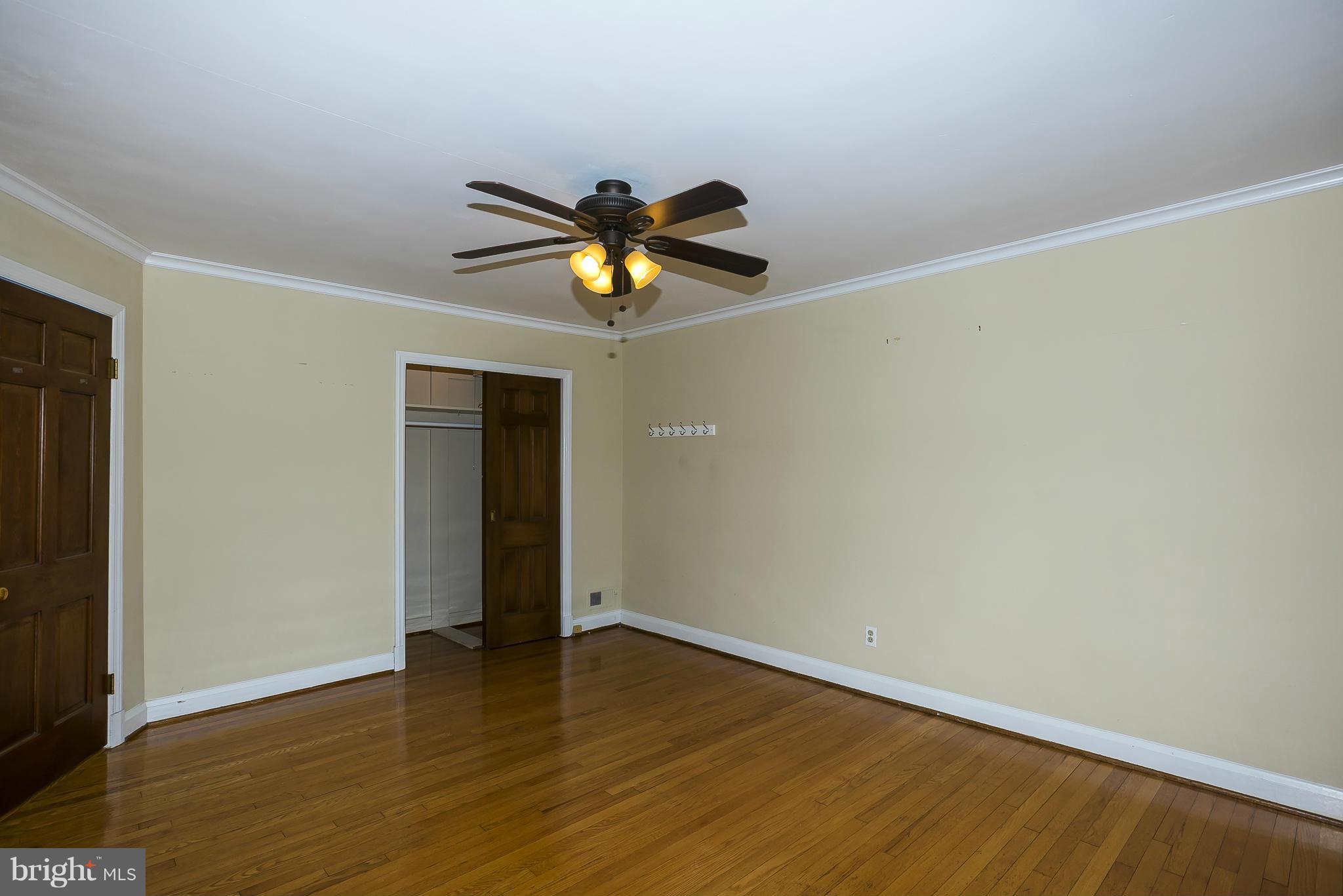 354 Greenlow Road Catonsville, MD 21228 - Photo 12 of 20 a view of an empty room with wooden floor and chandelier