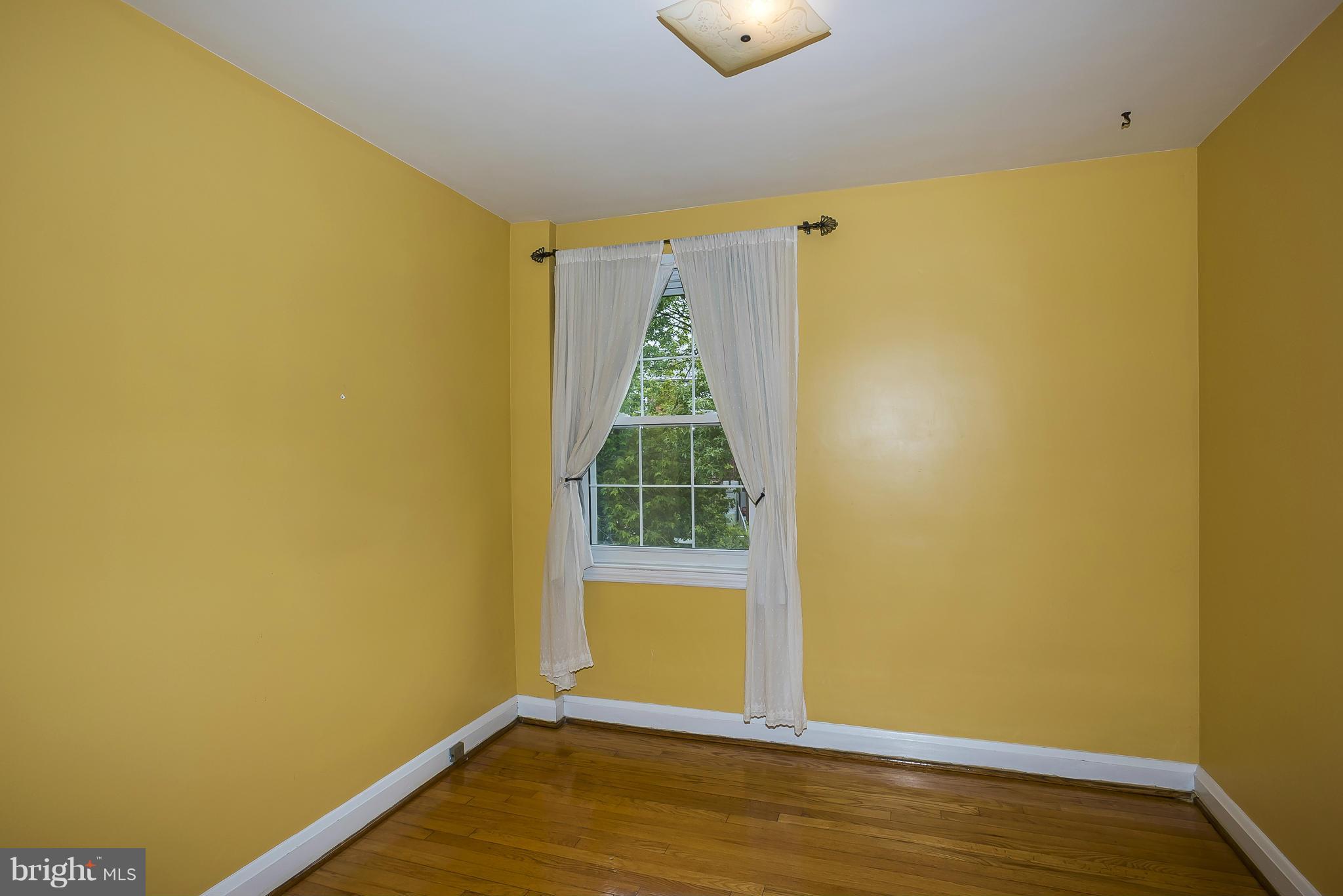 354 Greenlow Road Catonsville, MD 21228 - Photo 14 of 20 a view of a room with wooden floor and a window