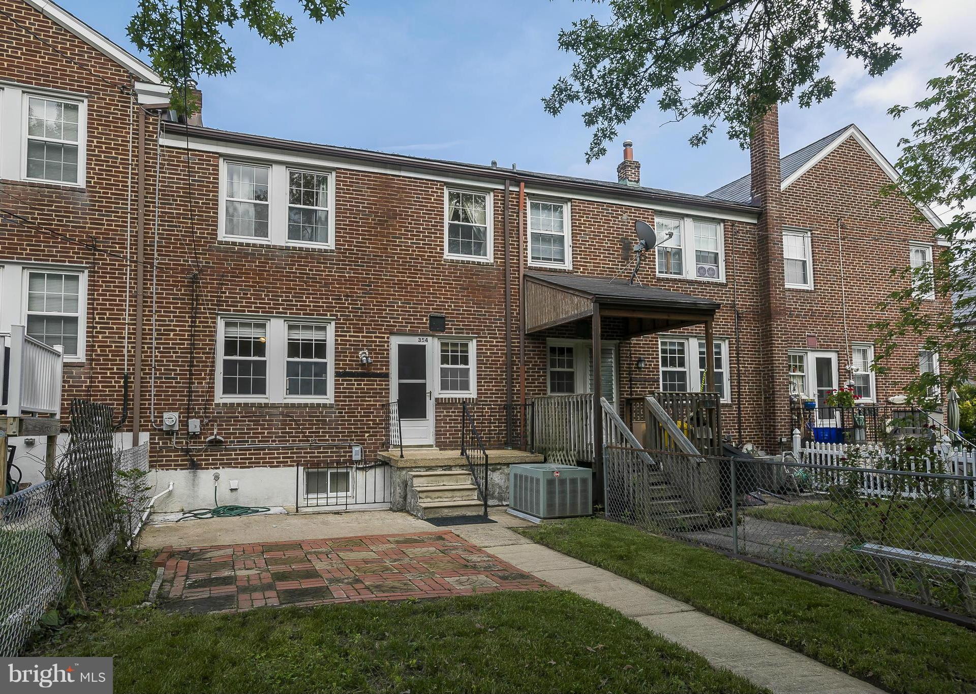 354 Greenlow Road Catonsville, MD 21228 - Photo 20 of 20 a view of a brick house with a yard and large tree