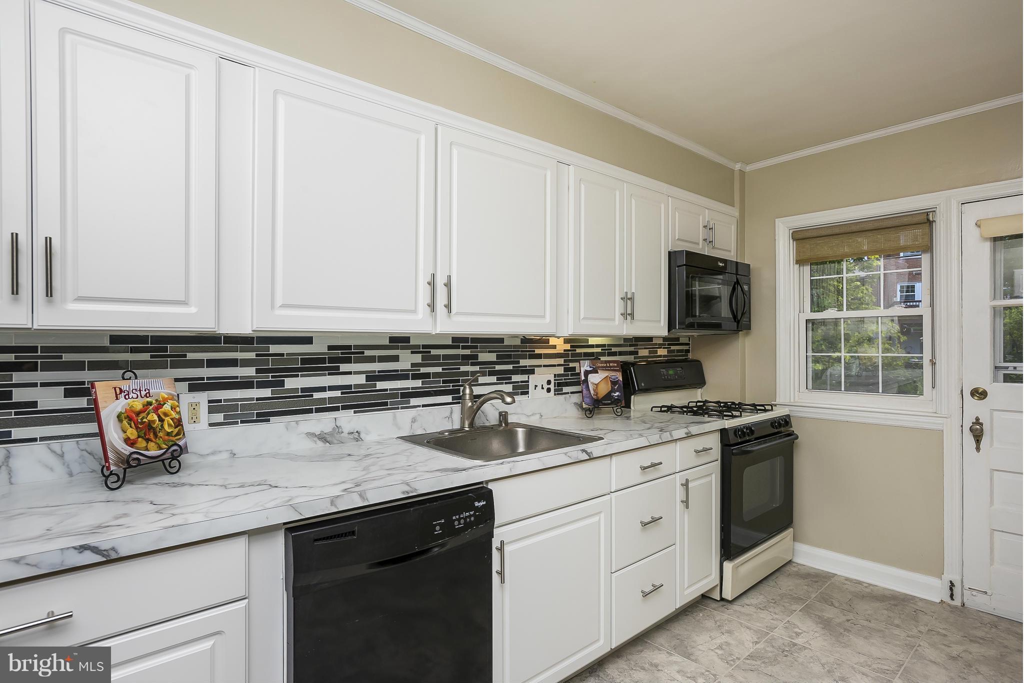 354 Greenlow Road Catonsville, MD 21228 - Photo 3 of 20 a kitchen with stainless steel appliances granite countertop a sink a stove and dishwasher with white cabinets