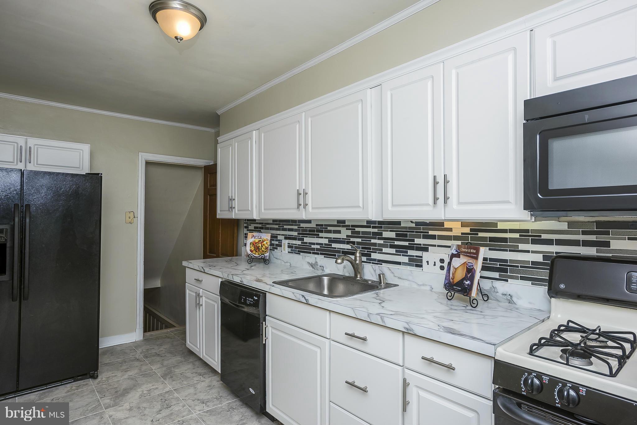 354 Greenlow Road Catonsville, MD 21228 - Photo 4 of 20 a kitchen with stainless steel appliances granite countertop a stove a sink and a refrigerator