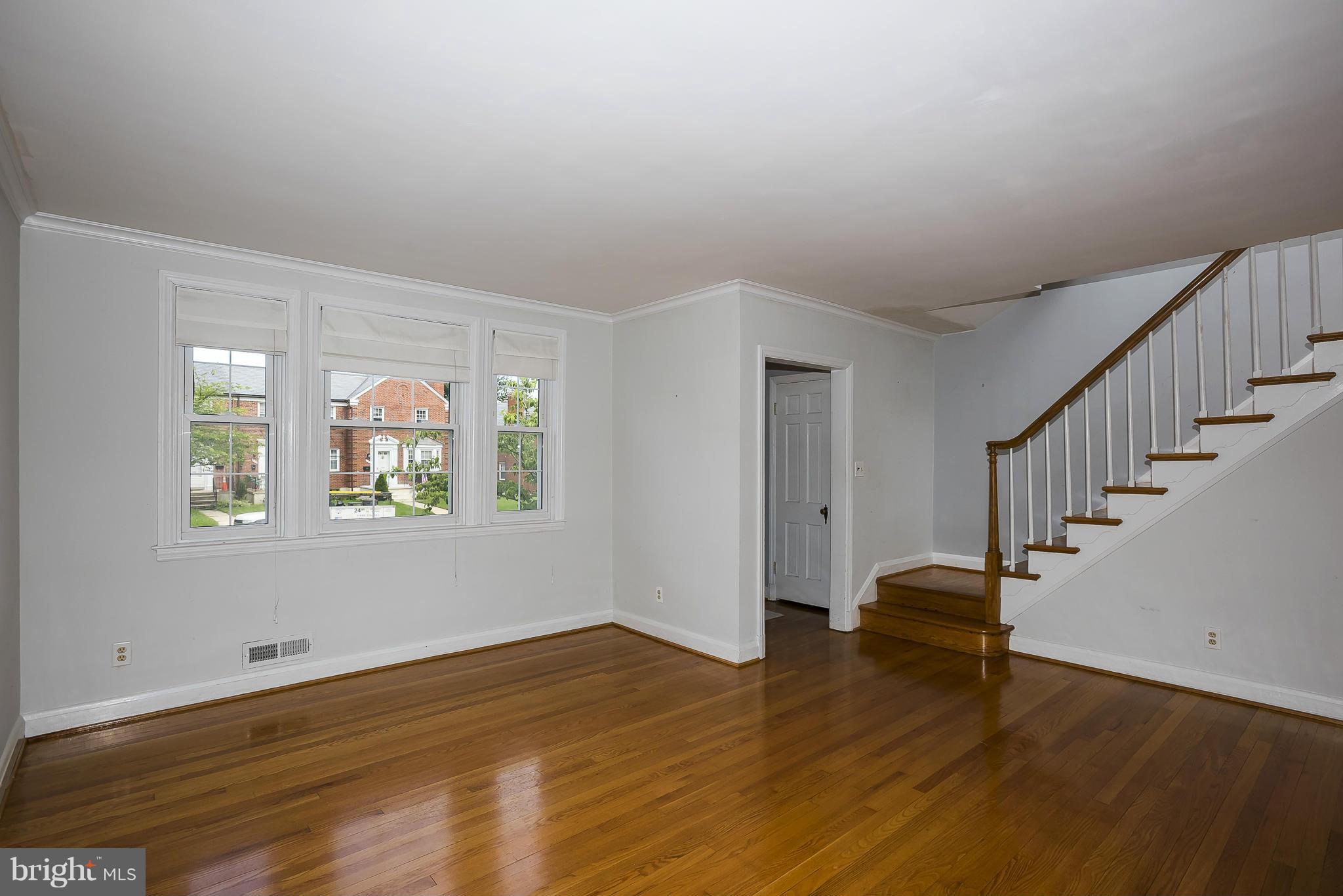 354 Greenlow Road Catonsville, MD 21228 - Photo 6 of 20 a view of an empty room with wooden floor and a window