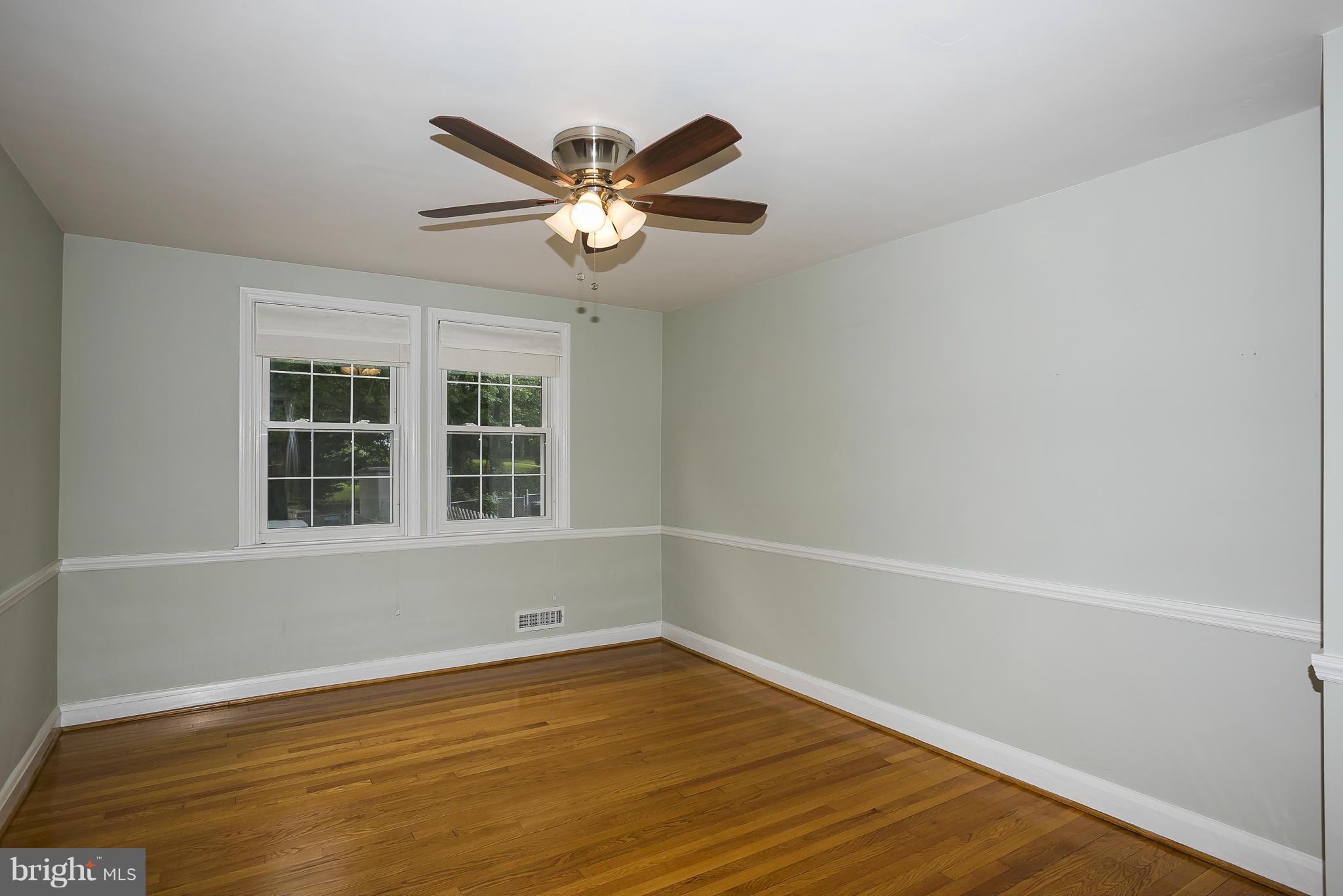 354 Greenlow Road Catonsville, MD 21228 - Photo 8 of 20 a view of an empty room with wooden floor and a window
