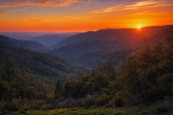 a view of a field with a mountain in the background