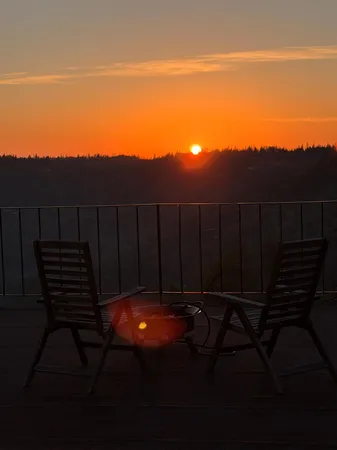 a view of a roof deck with wooden floor and city view