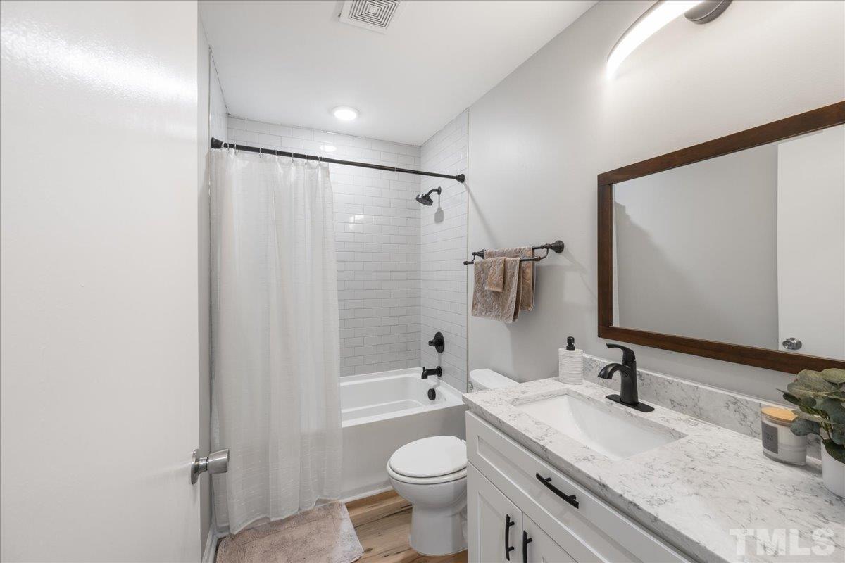 3101 Crandon Lane Raleigh, NC 27604 - Photo 11 of 18 a bathroom with a granite countertop sink toilet and shower