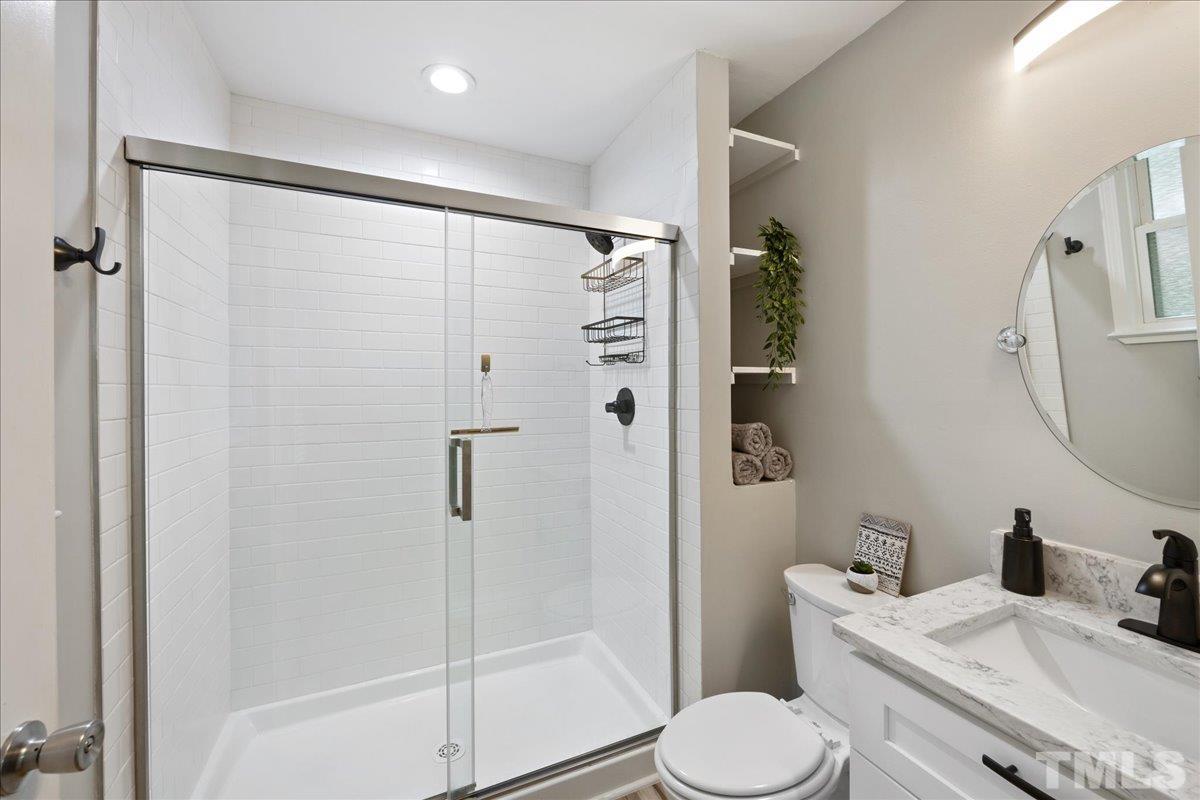3101 Crandon Lane Raleigh, NC 27604 - Photo 13 of 18 a bathroom with a toilet sink and shower