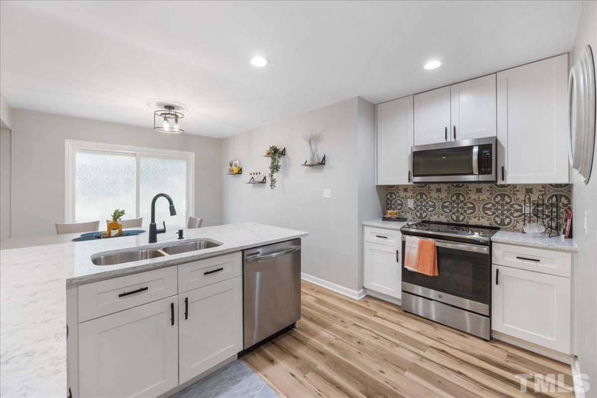 3101 Crandon Lane Raleigh, NC 27604 - Photo 7 of 18 a kitchen with a sink cabinets and stainless steel appliances