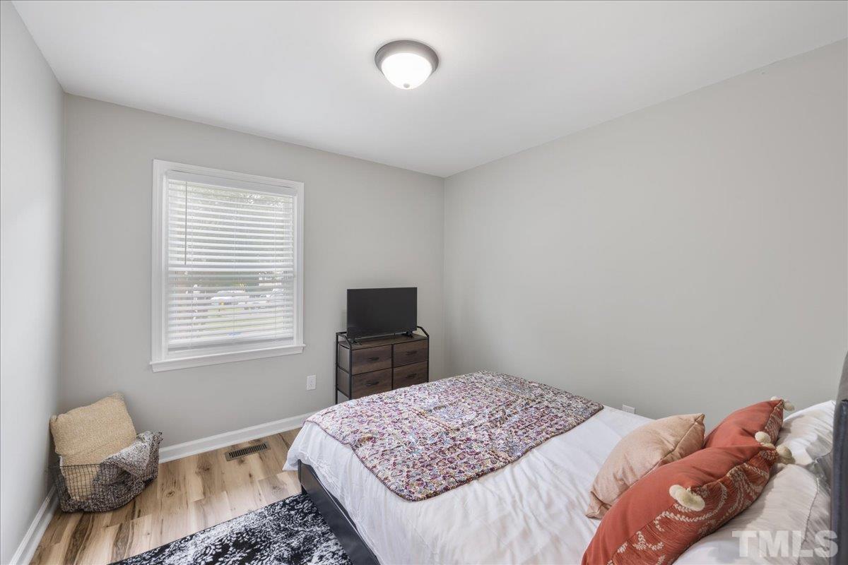 3101 Crandon Lane Raleigh, NC 27604 - Photo 9 of 18 a bedroom with a bed and a television