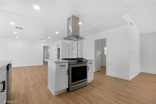 a kitchen with stainless steel appliances granite countertop a stove and a refrigerator