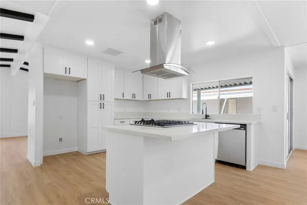 a kitchen with a sink stainless steel appliances and cabinets