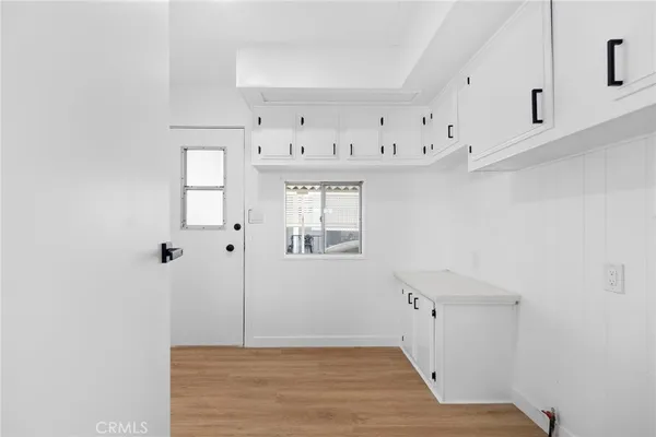 a view of kitchen with cabinets and wooden floor