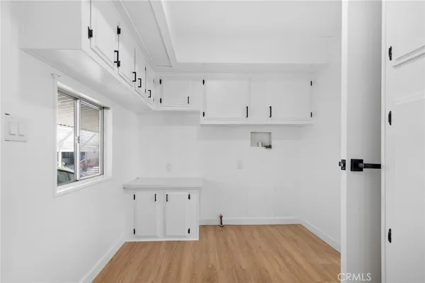 an empty room with wooden floor and a window