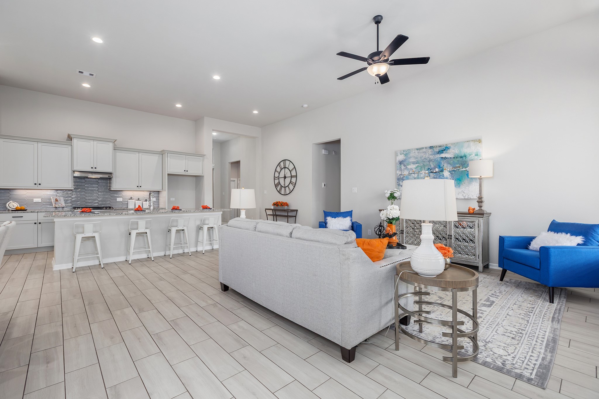 107 Yellow Perch Way Conroe, TX 77318 - Photo 11 of 44 Reverse view of the open-concept living area highlighting tile flooring, recessed lighting, and seamless flow into the kitchen with a large island and bar seating.